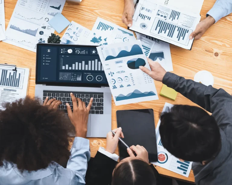 Marketing attribution consulting challenge shown by B2B team reviewing complex performance dashboards and reports