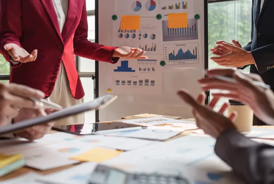 Team reviewing workflow and reporting materials for Chili Piper use cases